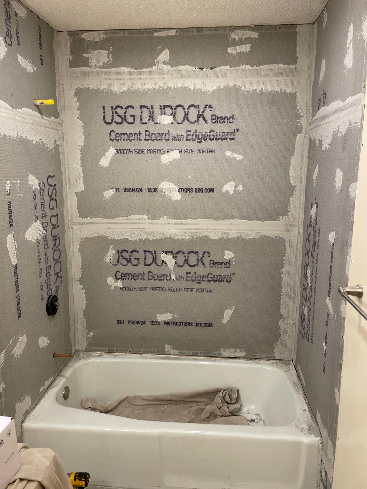 Bathroom walls stripped to cement board before tile install